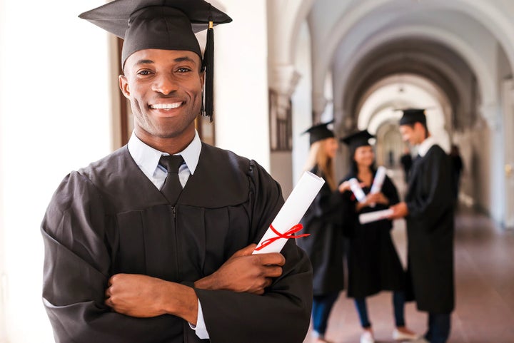 college graduate holding his diploma | i.g. Burton Subaru of Glen Burnie in Glen Burnie MD