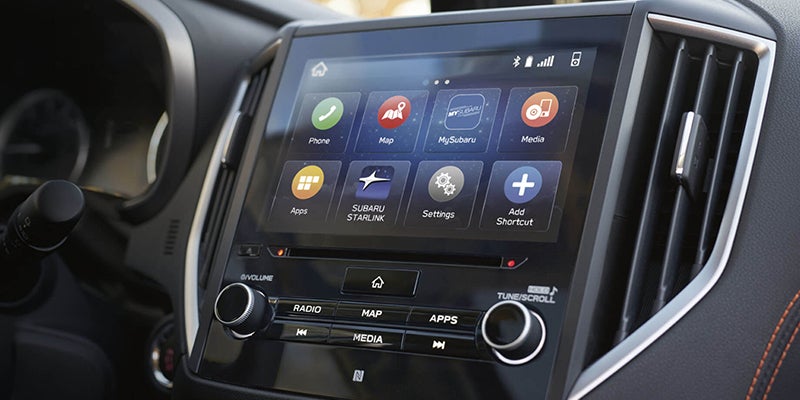 Car infotainment system with a large touch screen displaying apps like Phone, Map, MySubaru, and Media.