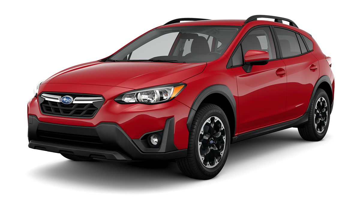 A shiny red Subaru Crosstrek SUV is parked, angled towards the left, against a black background