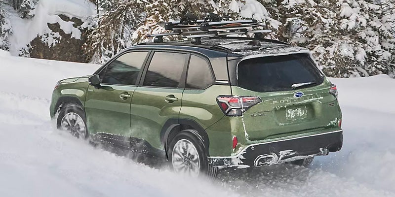 SUV Driving Through Snow-Covered Terrain