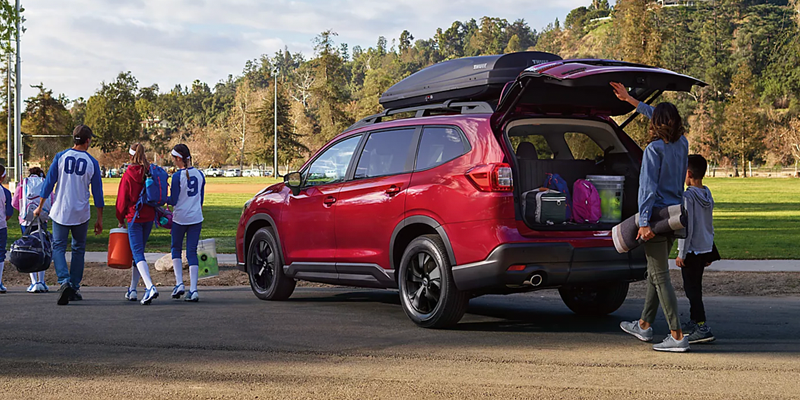 Red Three-Row SUV with Open Liftgate and Roof Cargo Carrier for Family Adventures