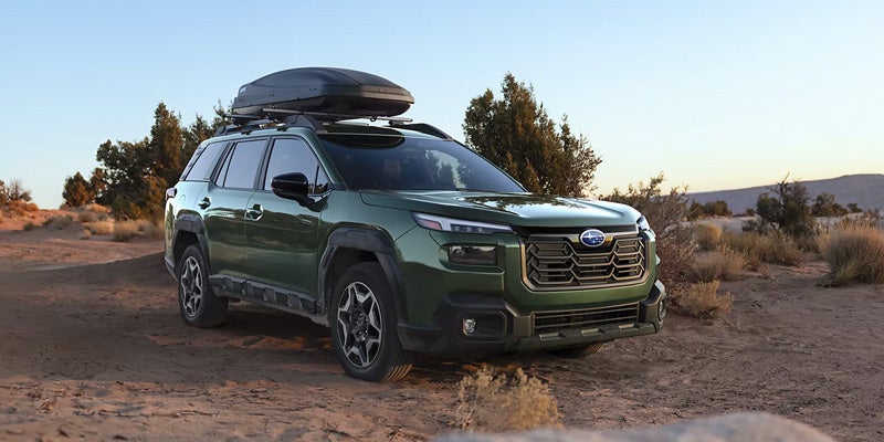 Green Adventure SUV with Roof Cargo Box in Desert Terrain