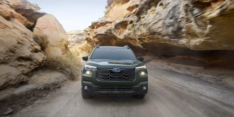 Outback SUV Driving Through a Rocky Canyon Road