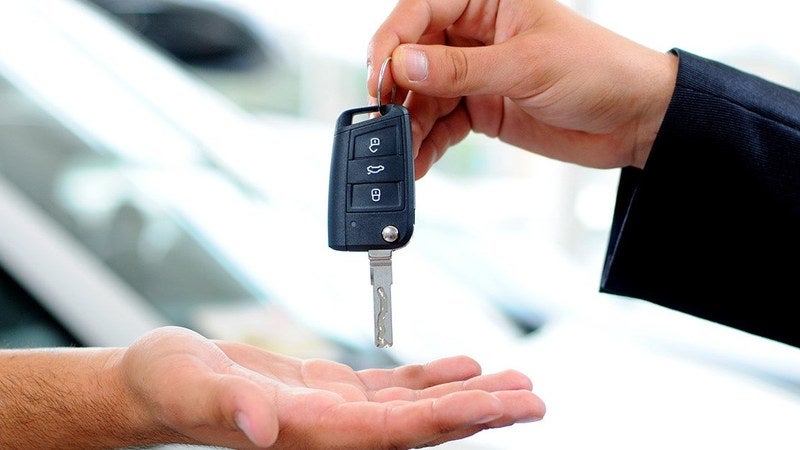 Handing over the keys to a new vehicle at a sales event