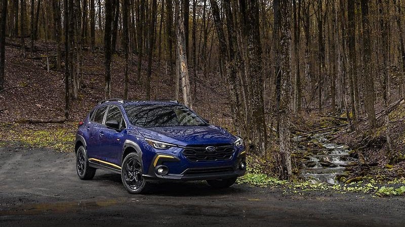 2026 Subaru Crosstrek in blue, three-quarter view in a forest