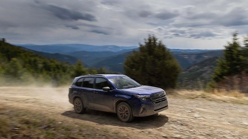2025 Subaru Forester on a dirt trail, three-quarter action shot
