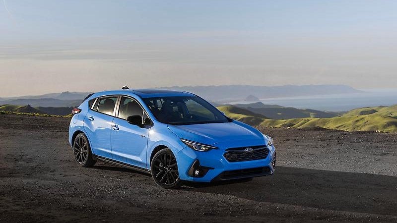 Subaru Impreza in blue, front three-quarter on a rural road