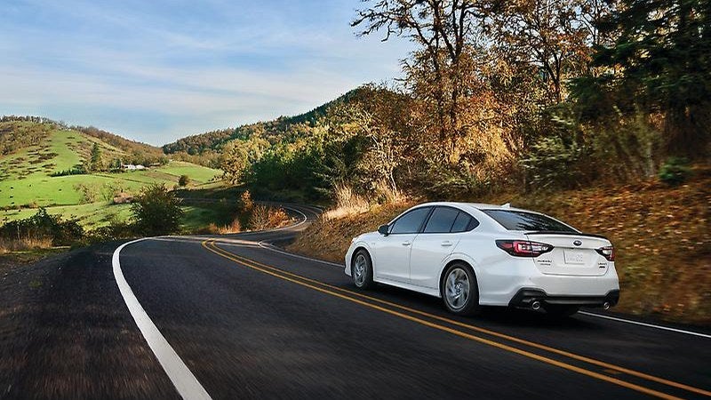 2024 Subaru Legacy sedan, rear three-quarter on an autumn road