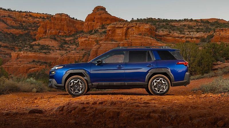 2026 Subaru Outback, blue, front three-quarter among red-rock terrain