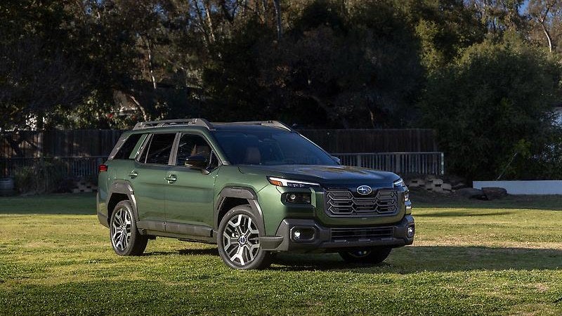 2024 Subaru Outback, green, three-quarter view in a field