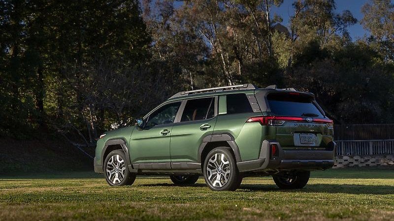 2024 Subaru Outback, green, three-quarter view in a field