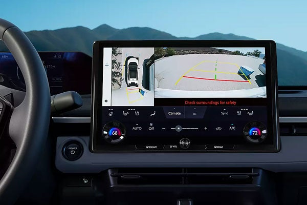 Dashboard touchscreen display inside a Subaru Solterra showing the 360-degree Panoramic View Monitor and backup camera.